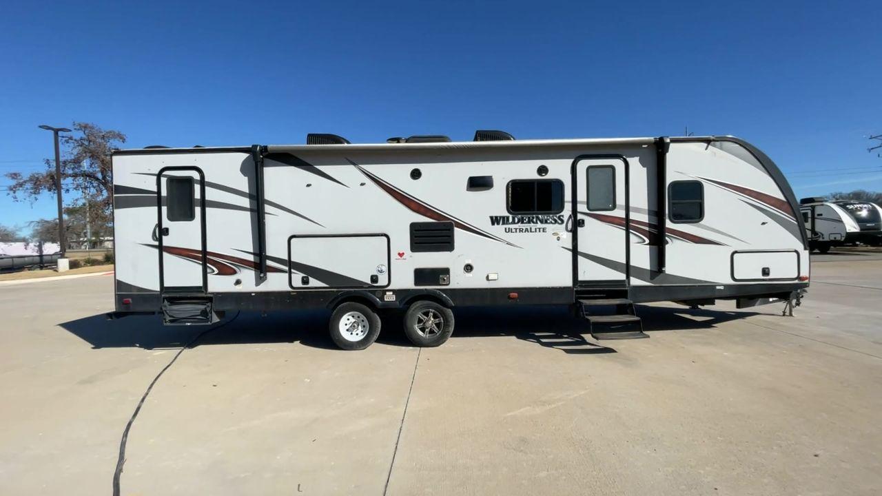 2018 GRAY HEARTLAND WILDERNESS USED 3125 (5SFNB3526JE) , Length: 35.75 ft. | Dry Weight: 6,840 lbs. | Gross Weight: 8,600 lbs. | Slides: 1 transmission, located at 4319 N Main Street, Cleburne, TX, 76033, (817) 221-0660, 32.435829, -97.384178 - Discover your inner adventurer with the Heartland Wilderness 3125 travel trailer from 2018. This RV offers the ideal balance of roomy living, contemporary conveniences, and tough sturdiness for your outdoor adventures. It is designed for individuals who desire both comfort and exploration. The dimen - Photo #2
