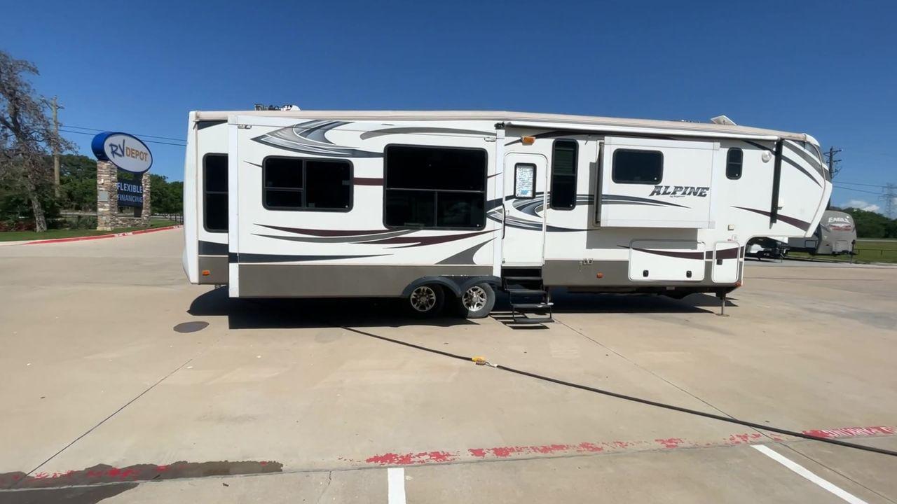 2013 WHITE KEYSTONE ALPNE 3720FB - (4YDF37227DE) , Length: 39.42 ft. | Dry Weight: 12,457 lbs. | Gross Weight: 15,500 lbs. | Slides: 4 transmission, located at 4319 N Main Street, Cleburne, TX, 76033, (817) 221-0660, 32.435829, -97.384178 - Explore more reasons that emphasize the benefits of having this RV as your own. (1) Its large living area features a slide-out with a sofa, recliner, and entertainment center with a fireplace and 32"" LCD TV. (2) It has U-shaped dinette with booth seating provides ample space for dining and ent - Photo #2