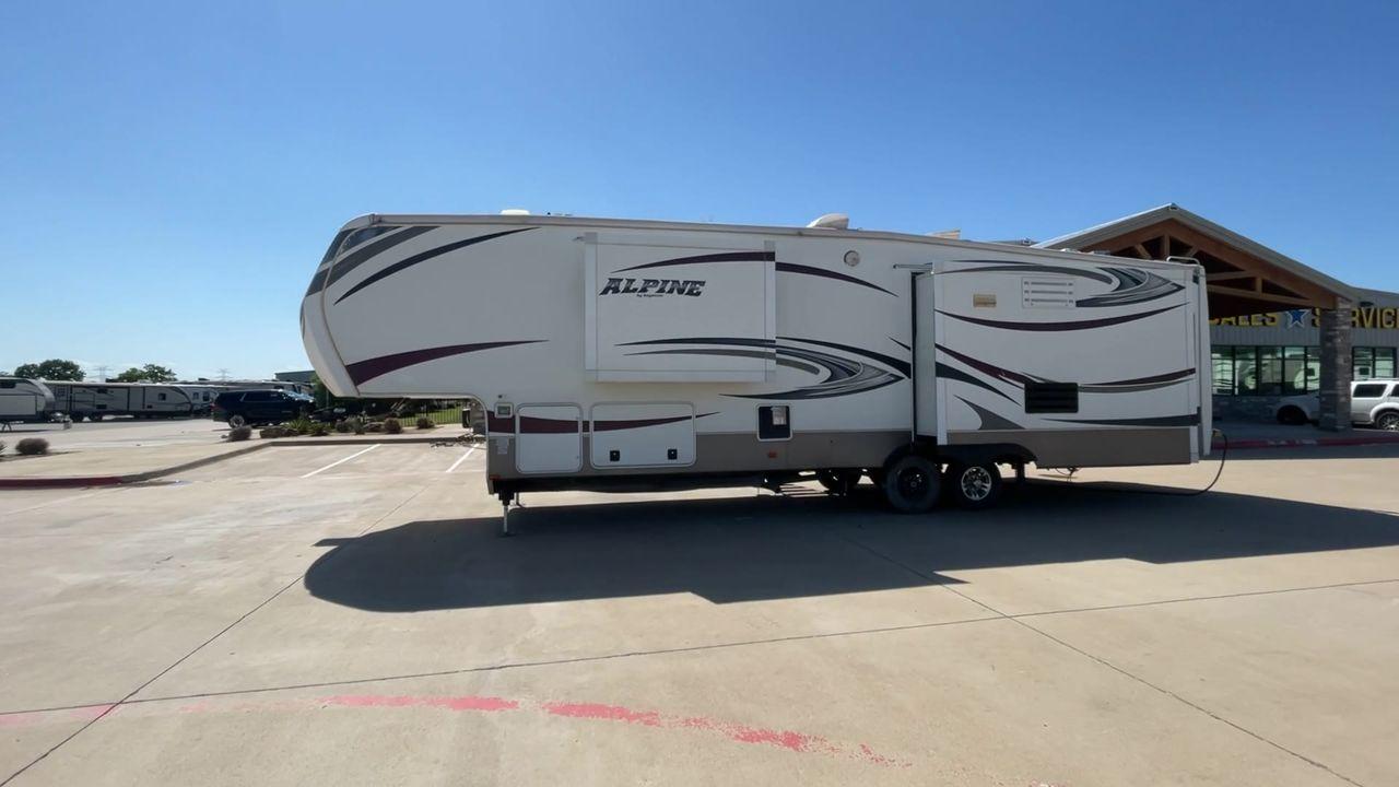 2013 WHITE KEYSTONE ALPNE 3720FB - (4YDF37227DE) , Length: 39.42 ft. | Dry Weight: 12,457 lbs. | Gross Weight: 15,500 lbs. | Slides: 4 transmission, located at 4319 N Main Street, Cleburne, TX, 76033, (817) 221-0660, 32.435829, -97.384178 - Explore more reasons that emphasize the benefits of having this RV as your own. (1) Its large living area features a slide-out with a sofa, recliner, and entertainment center with a fireplace and 32"" LCD TV. (2) It has U-shaped dinette with booth seating provides ample space for dining and ent - Photo #6