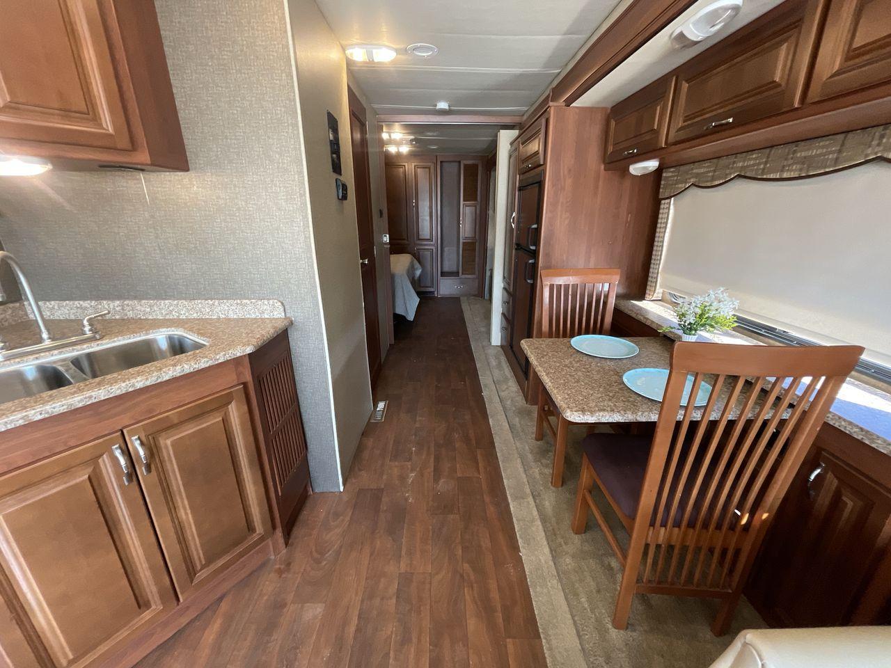 2014 BROWN HOLIDAY RAMBLER VACATIONER 33SFD - (1F66F5DY0D0) with an 6.8L V10 SOHC 30V engine, Length: 35 ft. | Slides: 2 transmission, located at 4319 N Main St, Cleburne, TX, 76033, (817) 678-5133, 32.385960, -97.391212 - The 2014 Holiday Rambler Vacationer 33SFD is a premium Class A motorhome that blends comfort and style for an unparalleled travel experience. This meticulously designed model is built on a Ford F53 chassis, powered by a robust Triton V10 engine to ensure a smooth and powerful ride. The Vacationer 33 - Photo #13