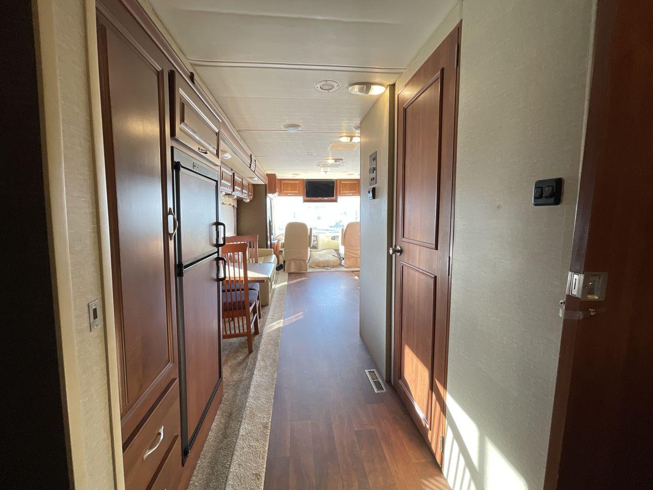 2014 BROWN HOLIDAY RAMBLER VACATIONER 33SFD - (1F66F5DY0D0) with an 6.8L V10 SOHC 30V engine, Length: 35 ft. | Slides: 2 transmission, located at 4319 N Main St, Cleburne, TX, 76033, (817) 678-5133, 32.385960, -97.391212 - The 2013 Holiday Rambler Vacationer 33SFD gives you the comfort and convenience of a residential home. The cockpit comes with a flat-screen TV above with lots of storage space. There is a comfy hide-a-bed sofa in the living area to have a comfortable view of the TV. Beside the couch is a free-standi - Photo #13