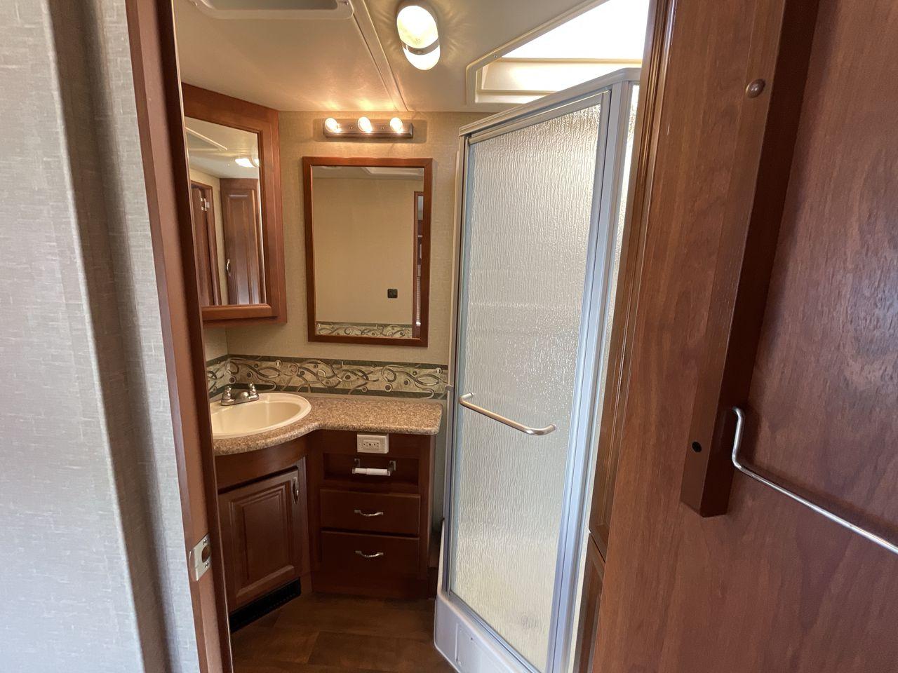 2014 BROWN HOLIDAY RAMBLER VACATIONER 33SFD - (1F66F5DY0D0) with an 6.8L V10 SOHC 30V engine, Length: 35 ft. | Slides: 2 transmission, located at 4319 N Main St, Cleburne, TX, 76033, (817) 678-5133, 32.385960, -97.391212 - The 2013 Holiday Rambler Vacationer 33SFD gives you the comfort and convenience of a residential home. The cockpit comes with a flat-screen TV above with lots of storage space. There is a comfy hide-a-bed sofa in the living area to have a comfortable view of the TV. Beside the couch is a free-standi - Photo #14