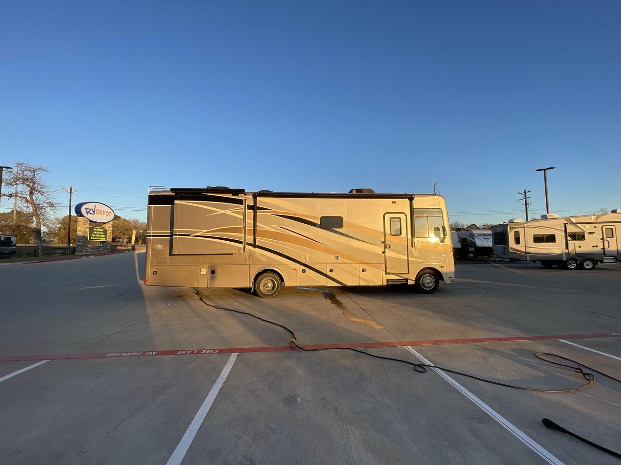 2014 BROWN HOLIDAY RAMBLER VACATIONER 33SFD - (1F66F5DY0D0) with an 6.8L V10 SOHC 30V engine, Length: 35 ft. | Slides: 2 transmission, located at 4319 N Main St, Cleburne, TX, 76033, (817) 678-5133, 32.385960, -97.391212 - The 2013 Holiday Rambler Vacationer 33SFD gives you the comfort and convenience of a residential home. The cockpit comes with a flat-screen TV above with lots of storage space. There is a comfy hide-a-bed sofa in the living area to have a comfortable view of the TV. Beside the couch is a free-standi - Photo #20