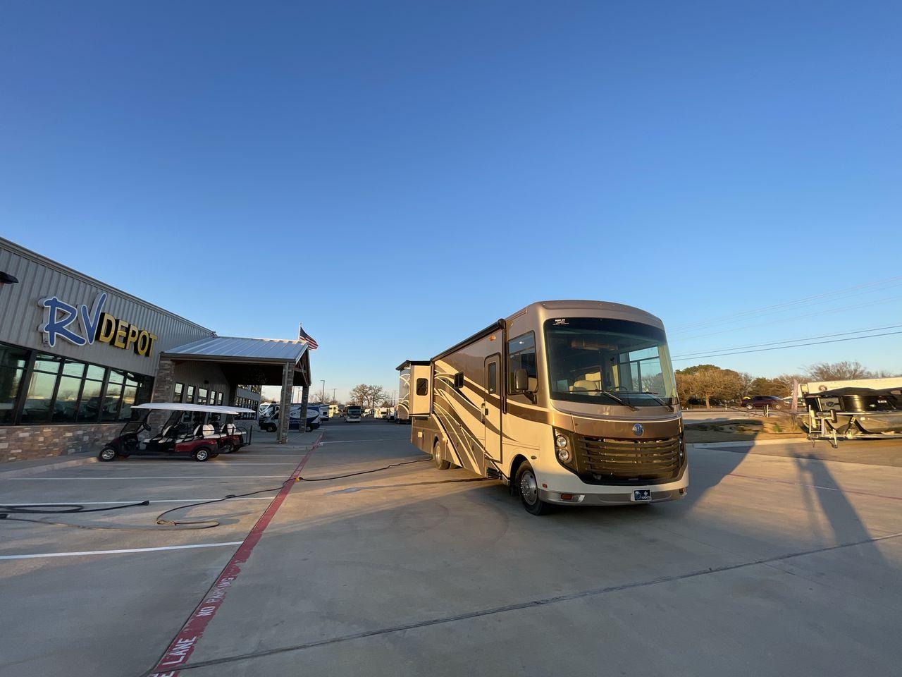 2014 BROWN HOLIDAY RAMBLER VACATIONER 33SFD - (1F66F5DY0D0) with an 6.8L V10 SOHC 30V engine, Length: 35 ft. | Slides: 2 transmission, located at 4319 N Main St, Cleburne, TX, 76033, (817) 678-5133, 32.385960, -97.391212 - The 2013 Holiday Rambler Vacationer 33SFD gives you the comfort and convenience of a residential home. The cockpit comes with a flat-screen TV above with lots of storage space. There is a comfy hide-a-bed sofa in the living area to have a comfortable view of the TV. Beside the couch is a free-standi - Photo #21