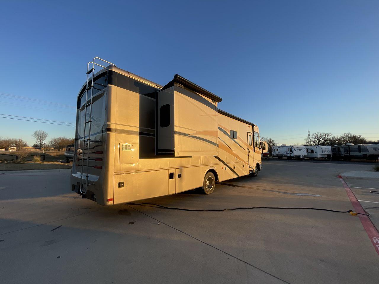 2014 BROWN HOLIDAY RAMBLER VACATIONER 33SFD - (1F66F5DY0D0) with an 6.8L V10 SOHC 30V engine, Length: 35 ft. | Slides: 2 transmission, located at 4319 N Main St, Cleburne, TX, 76033, (817) 678-5133, 32.385960, -97.391212 - The 2013 Holiday Rambler Vacationer 33SFD gives you the comfort and convenience of a residential home. The cockpit comes with a flat-screen TV above with lots of storage space. There is a comfy hide-a-bed sofa in the living area to have a comfortable view of the TV. Beside the couch is a free-standi - Photo #25