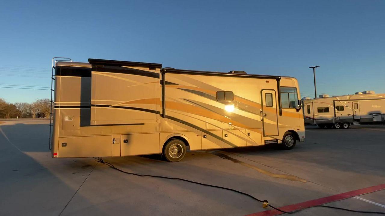 2014 BROWN HOLIDAY RAMBLER VACATIONER 33SFD - (1F66F5DY0D0) with an 6.8L V10 SOHC 30V engine, Length: 35 ft. | Slides: 2 transmission, located at 4319 N Main St, Cleburne, TX, 76033, (817) 678-5133, 32.385960, -97.391212 - The 2013 Holiday Rambler Vacationer 33SFD gives you the comfort and convenience of a residential home. The cockpit comes with a flat-screen TV above with lots of storage space. There is a comfy hide-a-bed sofa in the living area to have a comfortable view of the TV. Beside the couch is a free-standi - Photo #4