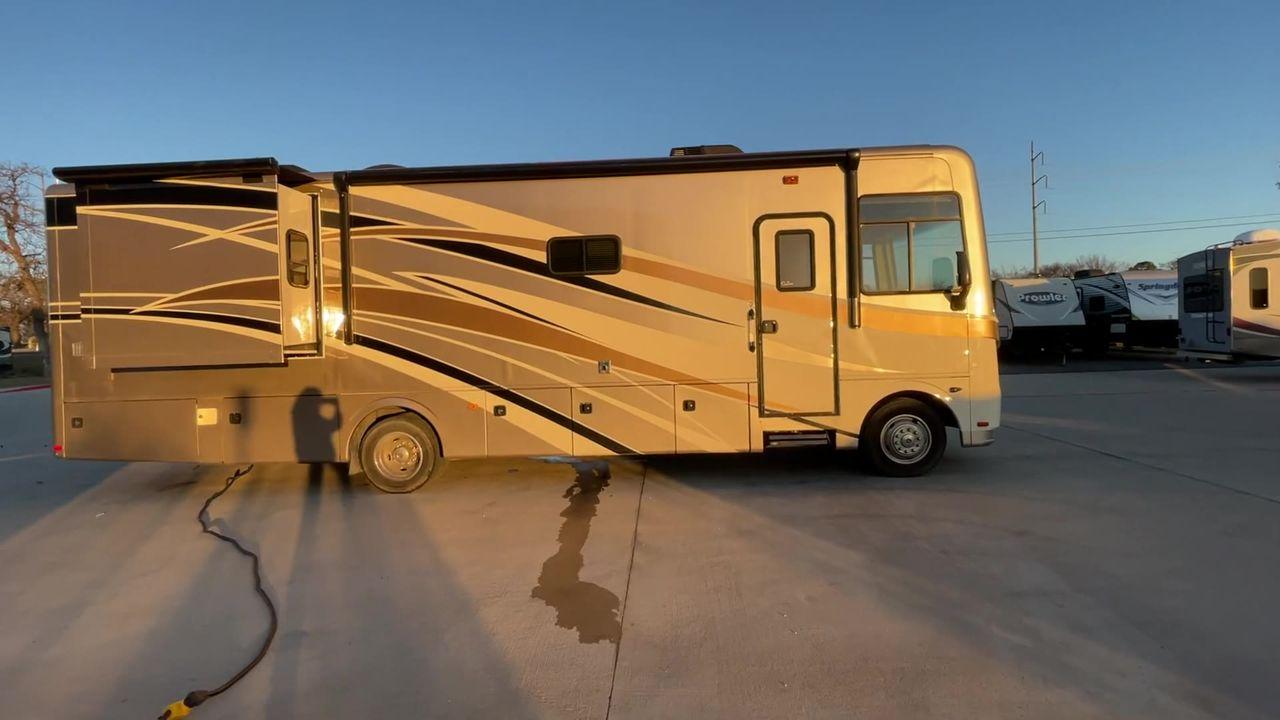 2014 BROWN HOLIDAY RAMBLER VACATIONER 33SFD - (1F66F5DY0D0) with an 6.8L V10 SOHC 30V engine, Length: 35 ft. | Slides: 2 transmission, located at 4319 N Main St, Cleburne, TX, 76033, (817) 678-5133, 32.385960, -97.391212 - The 2013 Holiday Rambler Vacationer 33SFD gives you the comfort and convenience of a residential home. The cockpit comes with a flat-screen TV above with lots of storage space. There is a comfy hide-a-bed sofa in the living area to have a comfortable view of the TV. Beside the couch is a free-standi - Photo #5