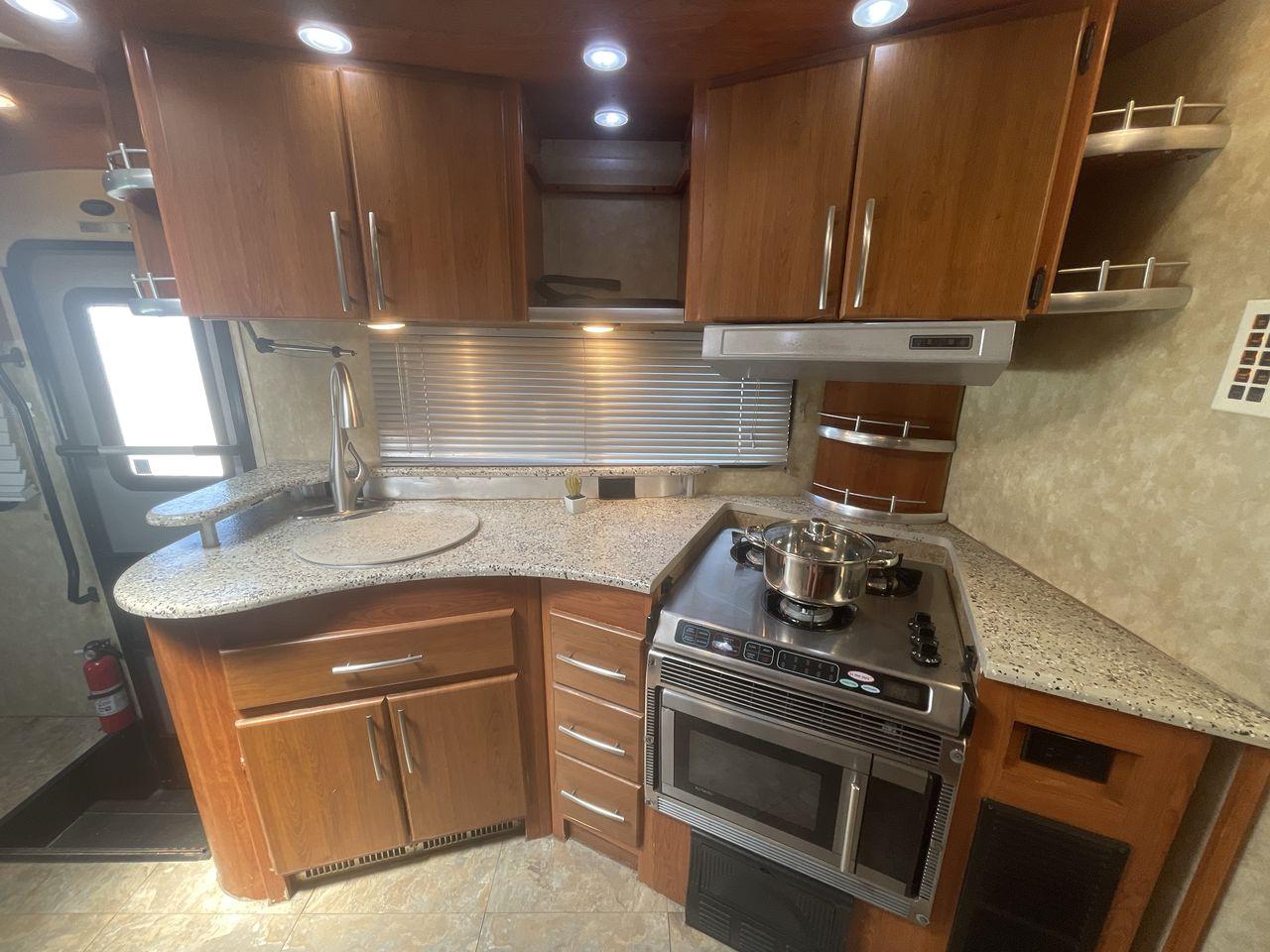 2008 TAN COACHMEN LEPRECHAUN 320DS E-450 (1FDXE45S08D) with an 6.8L V10 SOHC 20V engine, Length: 31.5 ft. | Dry Weight: 12,555 lbs. | Gross Weight: 14,500 lbs. | Slides: 2 transmission, located at 4319 N Main St, Cleburne, TX, 76033, (817) 678-5133, 32.385960, -97.391212 - Photo #9