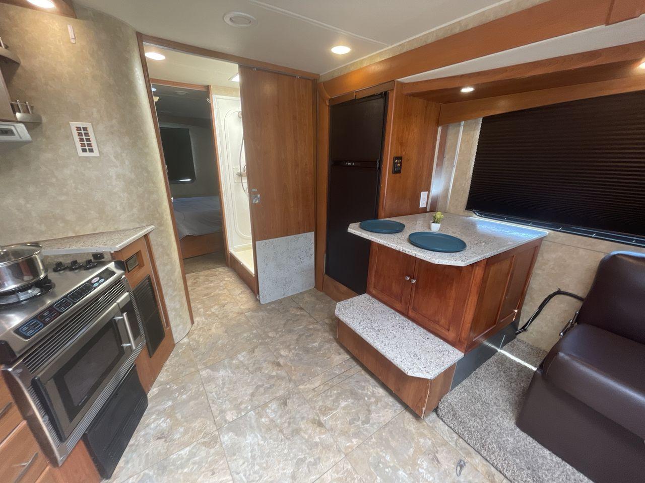 2008 TAN COACHMEN LEPRECHAUN 320DS E-450 (1FDXE45S08D) with an 6.8L V10 SOHC 20V engine, Length: 31.5 ft. | Dry Weight: 12,555 lbs. | Gross Weight: 14,500 lbs. | Slides: 2 transmission, located at 4319 N Main St, Cleburne, TX, 76033, (817) 678-5133, 32.385960, -97.391212 - Photo #12