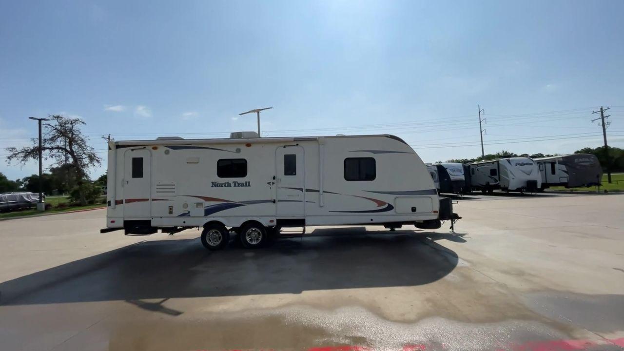 2011 WHITE HEARTLAND NORTH TRAIL 26B (5SFNB3225BE) , Length: 32.5 ft. | Dry Weight: 7,104 lbs. | Gross Weight: 8,600 lbs. | Slides: 2 transmission, located at 4319 N Main St, Cleburne, TX, 76033, (817) 678-5133, 32.385960, -97.391212 - Enjoy a spontaneous weekend getaway in this 2011 Heartland North Trail 26BRSS Travel Trailer! It is a dual-axle steel wheel setup measuring 32.5 ft. in length and 10.83 ft. in height. It has a dry weight of 7,104 lbs. and a GVWR of 8,600 lbs. It is equipped with automatic heating and cooling rated a - Photo #2