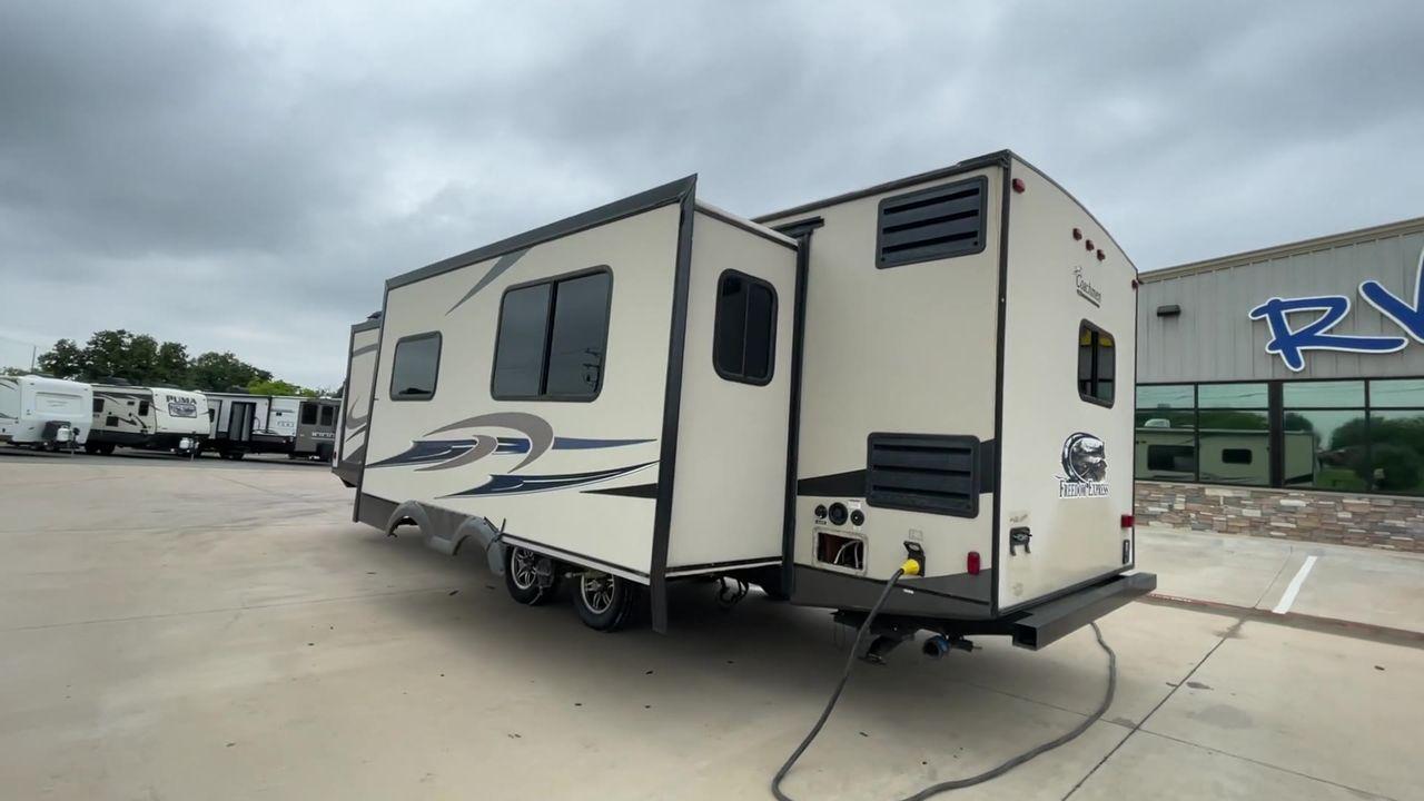 2015 TAN FREEDOM EXPRESS 305RKDS (5ZT2FEWB1FA) , Length: 34.5 ft. | Dry Weight: 6,199 lbs | Gross Weight: 9,500 lbs. | Slides: 2 transmission, located at 4319 N Main St, Cleburne, TX, 76033, (817) 678-5133, 32.385960, -97.391212 - The 2015 Freedom Express 305RKDS is a travel trailer designed to deliver an exceptional camping experience, combining freedom and comfort in every detail. It boasts a rear kitchen layout, providing a unique and functional living space. The rear kitchen is equipped with high-end appliances, ample cou - Photo #7