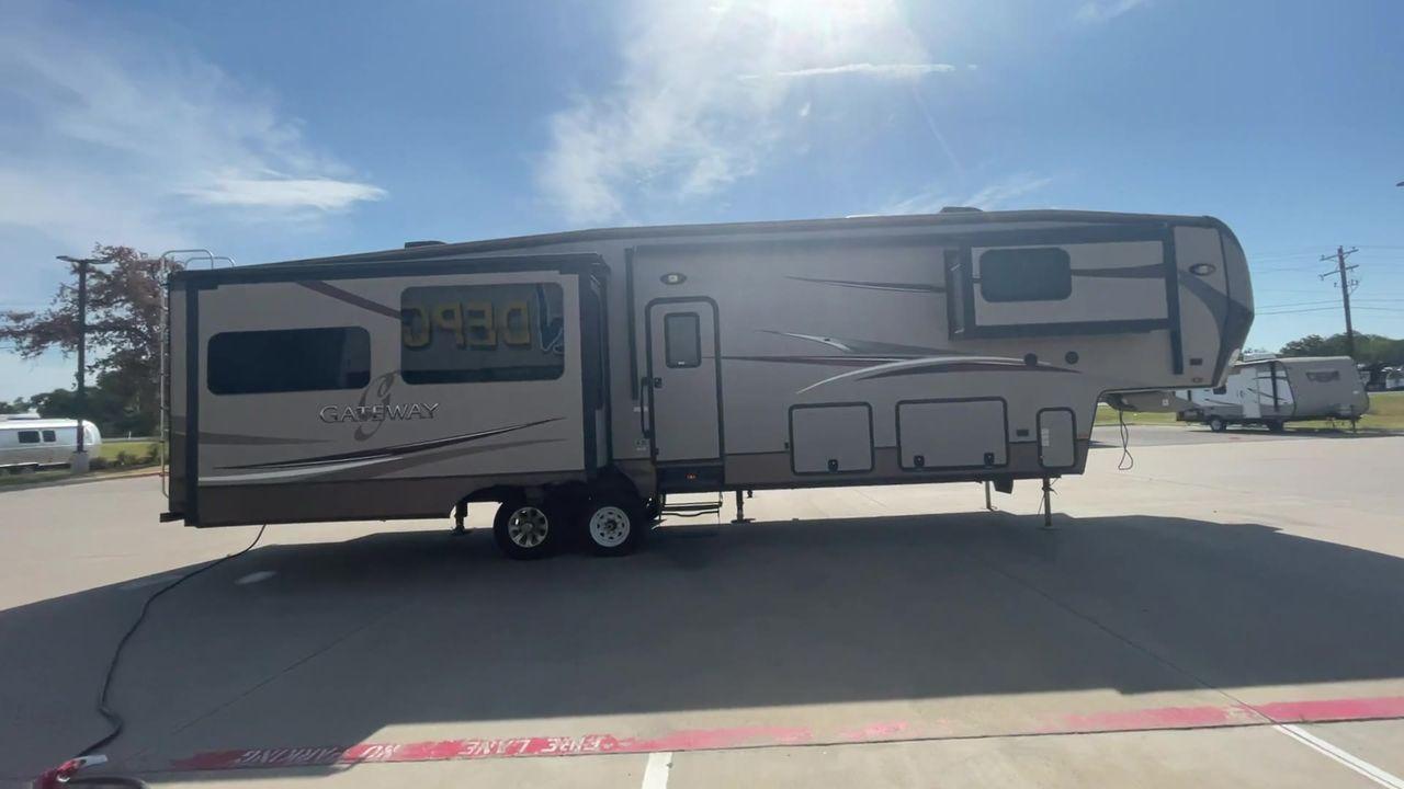 2015 BROWN HEARTLAND GATEWAY 3900SE (5SFSG4122FE) , Slides: 4 transmission, located at 4319 N Main St, Cleburne, TX, 76033, (817) 678-5133, 32.385960, -97.391212 - The 2015 Heartland Gateway 3900SE is a luxurious and spacious fifth-wheel RV designed for comfort and extended camping adventures. Measuring 41 feet in length and 8 feet in width, this RV offers ample space and a striking exterior. Constructed with a strong and lightweight aluminum frame, and fiberg - Photo #2