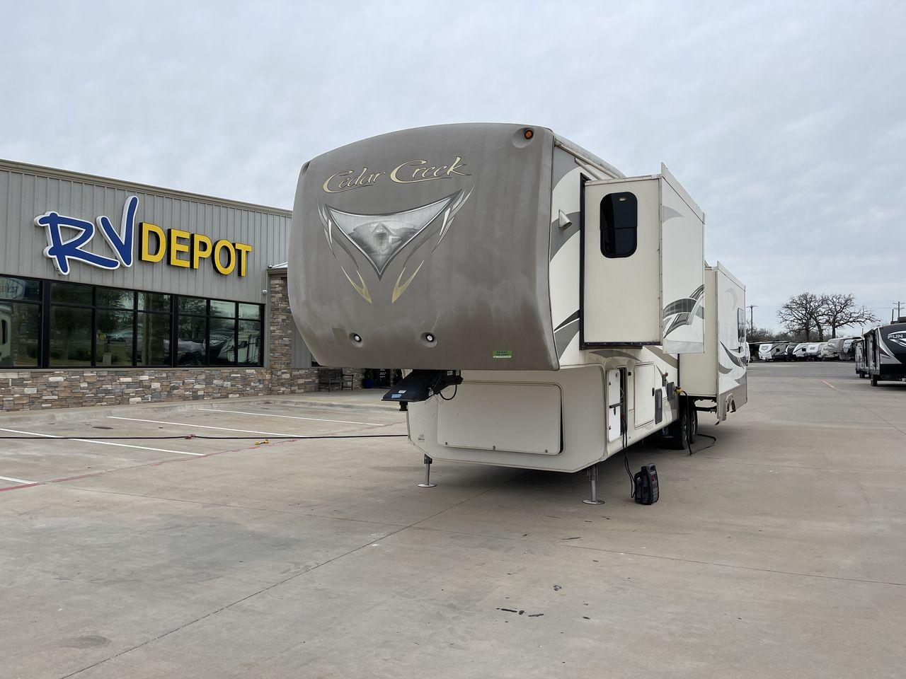 2014 TAN FOREST RIVER CEDAR CREEK 36CKTS (4X4FCRM26ES) , Length: 39.92 ft. | Dry Weight: 12,076 lbs. | Gross Weight: 16,389 lbs. | Slides: 3 transmission, located at 4319 N Main Street, Cleburne, TX, 76033, (817) 221-0660, 32.435829, -97.384178 - This 2014 Forest River Cedar Creek 36CKTS Fifth Wheel measures just shy of 40 feet long and 8 feet wide. This model has a GVWR of 16,389 and a hitch weight of 2,389 lbs. This unit is equipped with heating rated at 40,000 BTUs, and cooling rated at 15,000 BTUs, meaning it will always be exactly the t - Photo #0