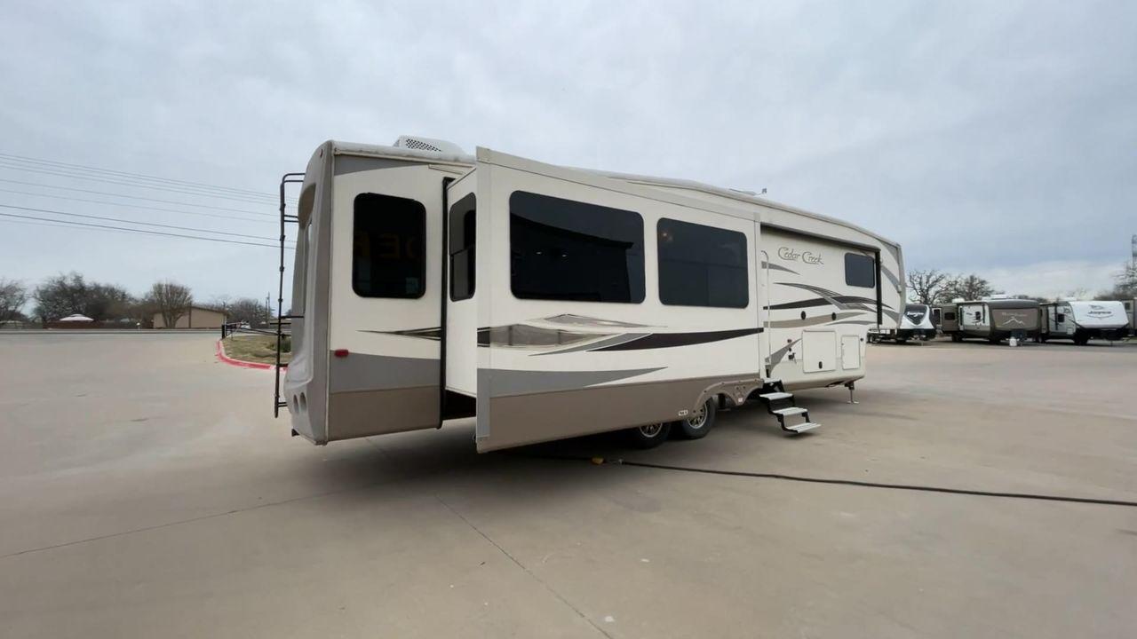 2014 TAN FOREST RIVER CEDAR CREEK 36CKTS (4X4FCRM26ES) , Length: 39.92 ft. | Dry Weight: 12,076 lbs. | Gross Weight: 16,389 lbs. | Slides: 3 transmission, located at 4319 N Main St, Cleburne, TX, 76033, (817) 678-5133, 32.385960, -97.391212 - This 2014 Forest River Cedar Creek 36CKTS Fifth Wheel measures just shy of 40 feet long and 8 feet wide. This model has a GVWR of 16,389 and a hitch weight of 2,389 lbs. This unit is equipped with heating rated at 40,000 BTUs, and cooling rated at 15,000 BTUs, meaning it will always be exactly the t - Photo #1