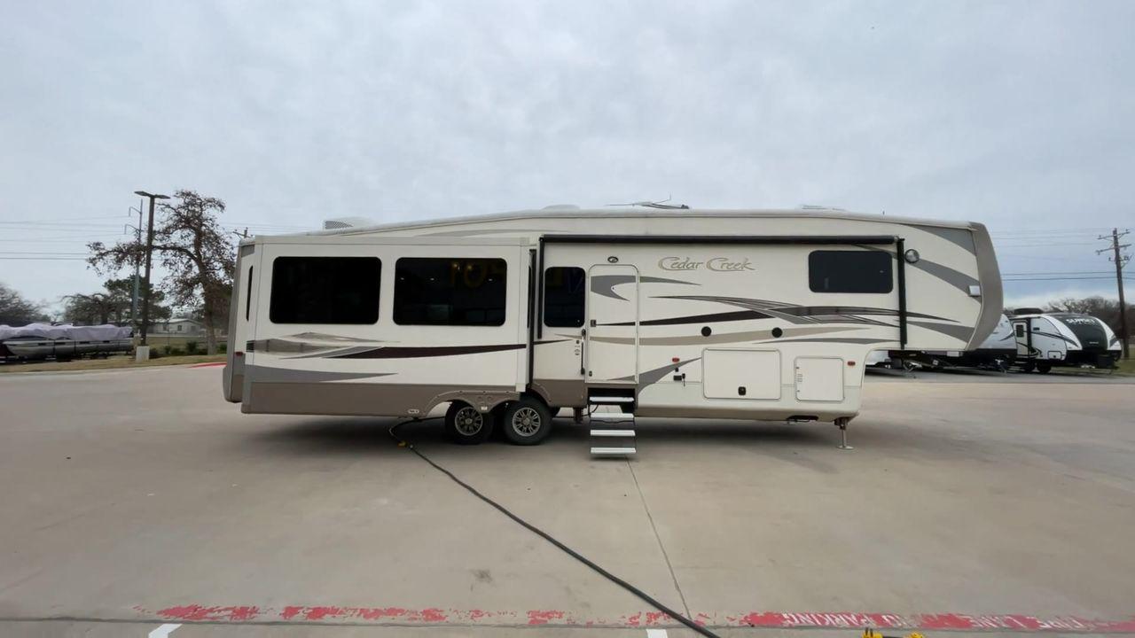 2014 TAN FOREST RIVER CEDAR CREEK 36CKTS (4X4FCRM26ES) , Length: 39.92 ft. | Dry Weight: 12,076 lbs. | Gross Weight: 16,389 lbs. | Slides: 3 transmission, located at 4319 N Main St, Cleburne, TX, 76033, (817) 678-5133, 32.385960, -97.391212 - This 2014 Forest River Cedar Creek 36CKTS Fifth Wheel measures just shy of 40 feet long and 8 feet wide. This model has a GVWR of 16,389 and a hitch weight of 2,389 lbs. This unit is equipped with heating rated at 40,000 BTUs, and cooling rated at 15,000 BTUs, meaning it will always be exactly the t - Photo #2