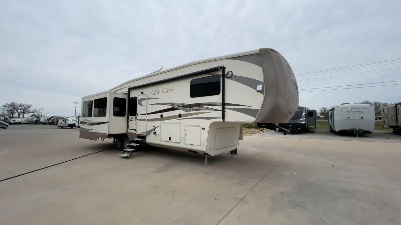 2014 TAN FOREST RIVER CEDAR CREEK 36CKTS (4X4FCRM26ES) , Length: 39.92 ft. | Dry Weight: 12,076 lbs. | Gross Weight: 16,389 lbs. | Slides: 3 transmission, located at 4319 N Main St, Cleburne, TX, 76033, (817) 678-5133, 32.385960, -97.391212 - This 2014 Forest River Cedar Creek 36CKTS Fifth Wheel measures just shy of 40 feet long and 8 feet wide. This model has a GVWR of 16,389 and a hitch weight of 2,389 lbs. This unit is equipped with heating rated at 40,000 BTUs, and cooling rated at 15,000 BTUs, meaning it will always be exactly the t - Photo #3