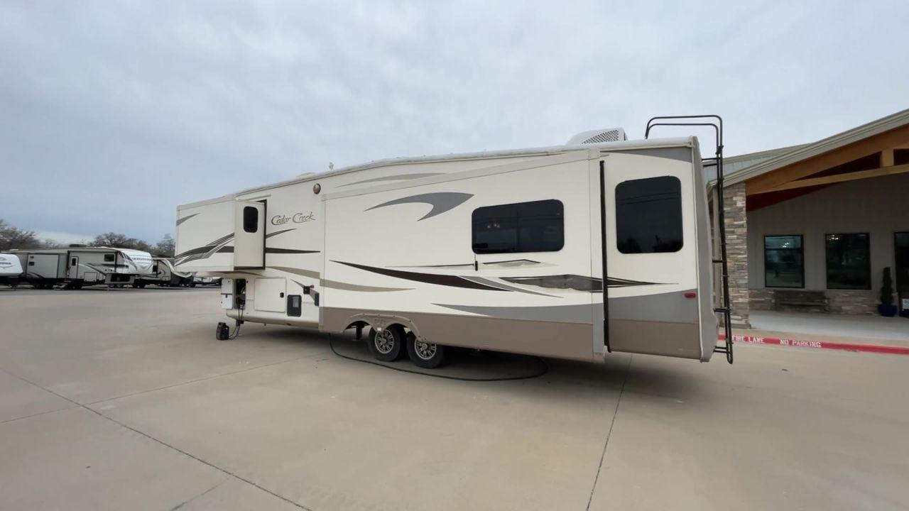 2014 TAN FOREST RIVER CEDAR CREEK 36CKTS (4X4FCRM26ES) , Length: 39.92 ft. | Dry Weight: 12,076 lbs. | Gross Weight: 16,389 lbs. | Slides: 3 transmission, located at 4319 N Main Street, Cleburne, TX, 76033, (817) 221-0660, 32.435829, -97.384178 - This 2014 Forest River Cedar Creek 36CKTS Fifth Wheel measures just shy of 40 feet long and 8 feet wide. This model has a GVWR of 16,389 and a hitch weight of 2,389 lbs. This unit is equipped with heating rated at 40,000 BTUs, and cooling rated at 15,000 BTUs, meaning it will always be exactly the t - Photo #7