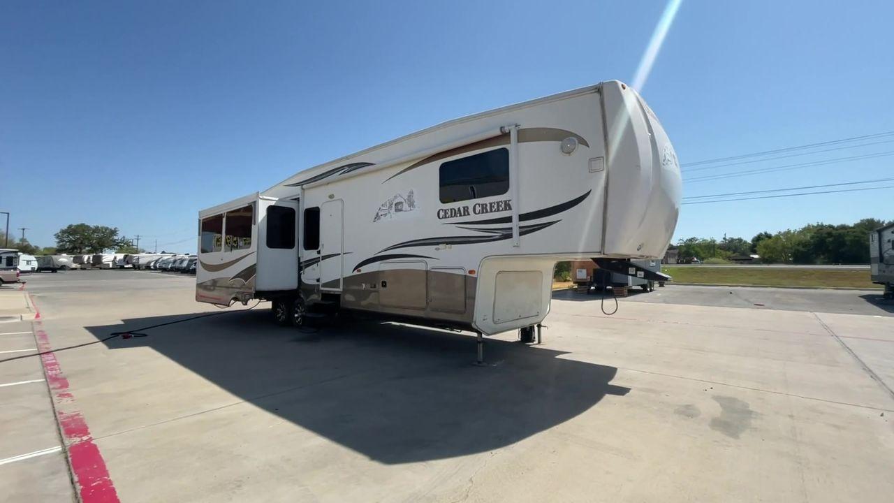 2011 WHITE CEDAR CREEK 36RE - (4X4FCRM24BS) , Length: 39 ft. | Dry Weight: 12,095 lbs. | Gross Weight: 15,500 lbs. | Slides: 3 transmission, located at 4319 N Main Street, Cleburne, TX, 76033, (817) 221-0660, 32.435829, -97.384178 - The 2011 Forest River Cedar Creek 36RE is a spacious and meticulously designed fifth-wheel RV, measuring 39 feet in length and 8 feet in width. With a dry weight of 12,095 lbs and a substantial GVWR of 15,500 lbs, this RV strikes a balance between size and towing efficiency. The aluminum superstruct - Photo #3