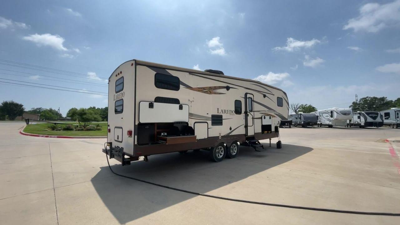 2015 WHITE KEYSTONE LAREDO 285SBH (4YDF28522FK) , Length: 33 ft. | Dry Weight: 7,880 lbs. | Gross Weight: 9,580 lbs. | Slides: 1 transmission, located at 4319 N Main Street, Cleburne, TX, 76033, (817) 221-0660, 32.435829, -97.384178 - This 2015 Keystone Fifth Wheel measures 33 feet long and 8 feet wide with a dry weight of 7,880 lbs. It has a GVWR of 9,580 lbs and a hitch weight of 1,465 lbs. This model also comes with automatic heating and cooling rated at 30,000 and 13,500 BTUs respectively. The exterior of this unit is a base - Photo #1