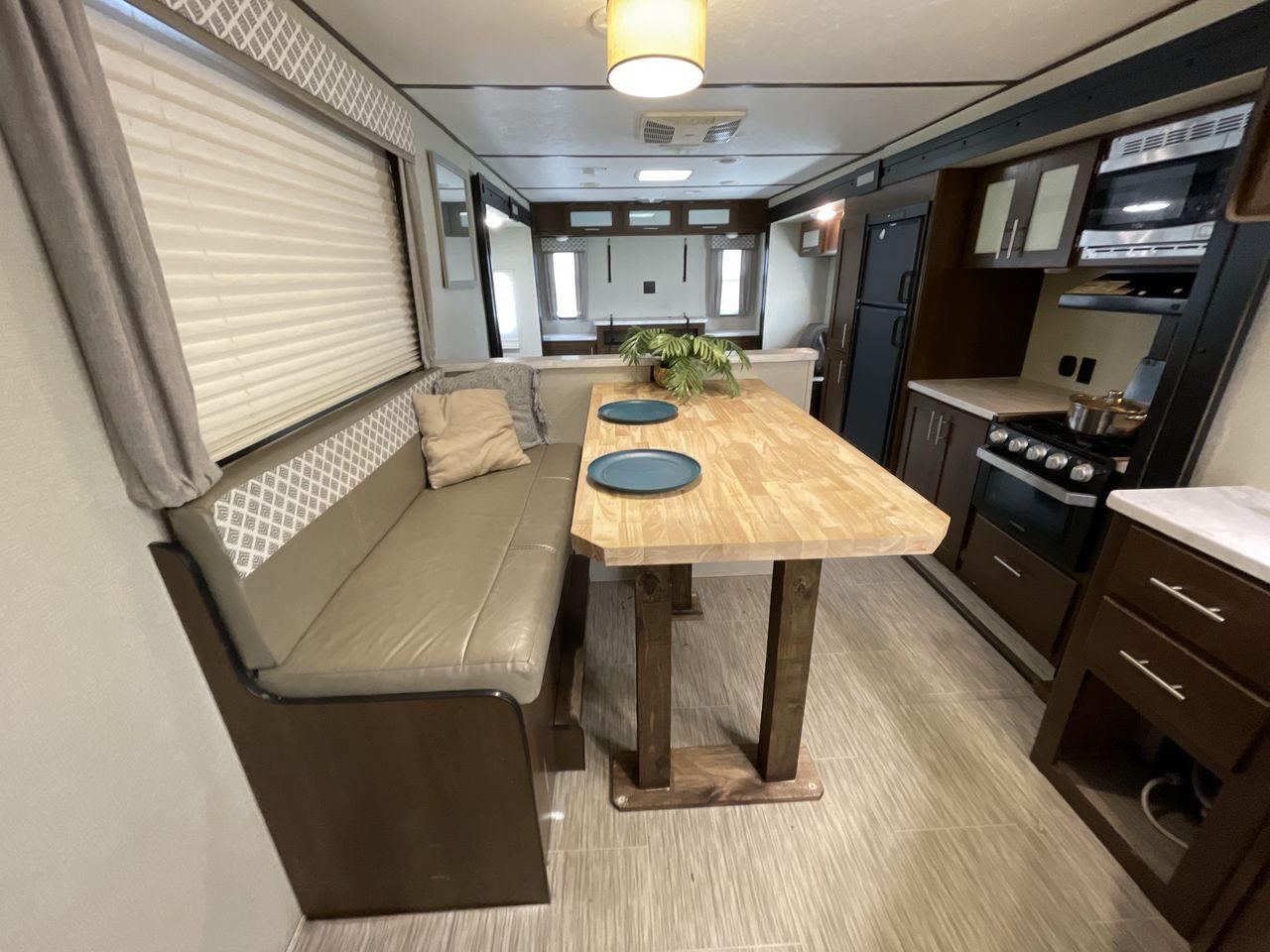 2019 TAN FOREST RIVER AVENGER 32DEN (5ZT2AVXB6KB) , Length: 37.92 ft. | Dry Weight: 7,989 lbs. | Slides: 2 transmission, located at 4319 N Main St, Cleburne, TX, 76033, (817) 678-5133, 32.385960, -97.391212 - Measuring an impressive 36 feet, this model unfolds to reveal two strategically placed slide-outs, creating a spacious haven for relaxation. The master bedroom welcomes you with a queen-size bed and ample storage, ensuring a peaceful retreat after a day of outdoor exploration. The living area is a h - Photo #13