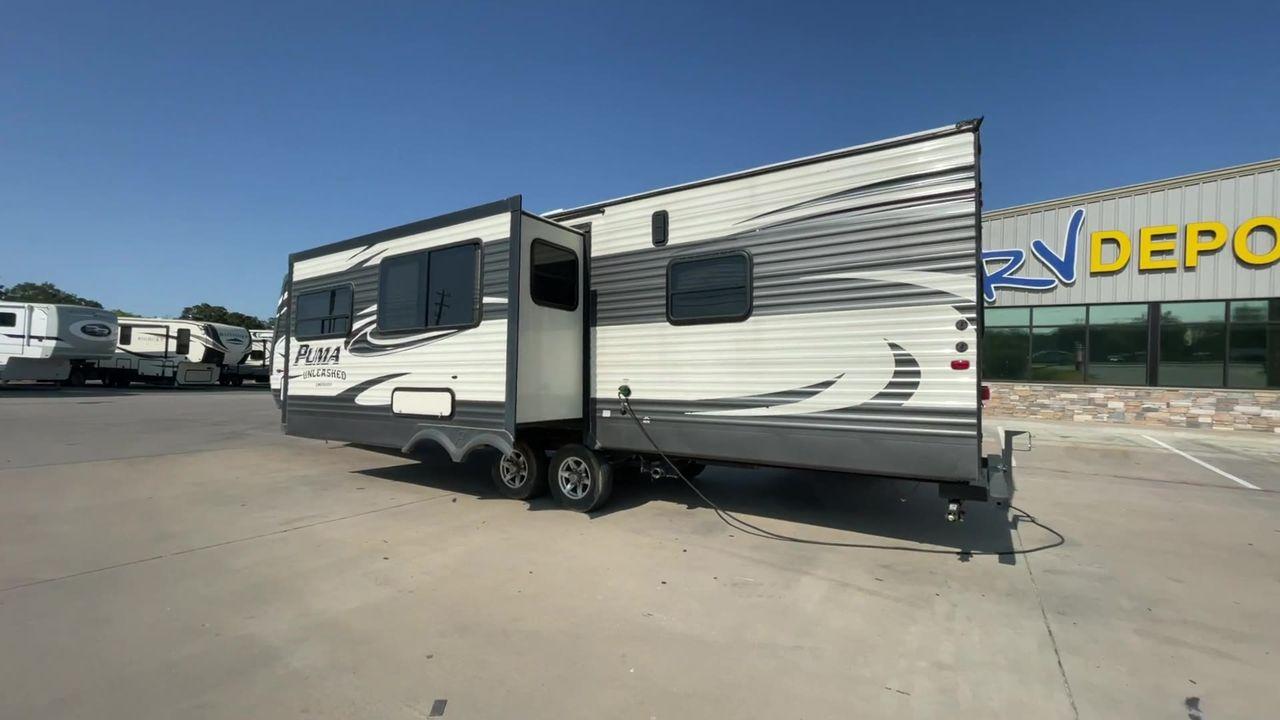 2015 PALOMINO PUMA UNLEASHED 30THS (4X4TPTF22FP) , Length: 35.33 ft. | Dry Weight: 7,345 lbs. | Gross Weight: 10,879 lbs. | Slides: 1 transmission, located at 4319 N Main St, Cleburne, TX, 76033, (817) 678-5133, 32.385960, -97.391212 - The 2015 Palomino Puma Unleashed 30THS is a dual-axle steel wheel setup measuring 35.33 ft. in length. It has a dry weight of 7,345 lbs. and a GVWR of 10,879 lbs. Its exterior is a base color of tan with cool black graphics. It includes one power slide as well as one 16-foot power awning. This toy h - Photo #1