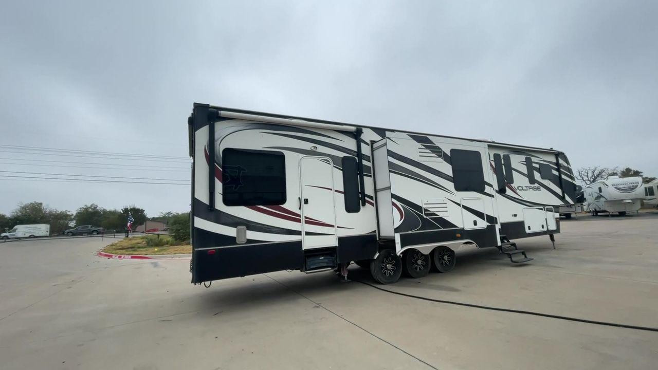 2014 DUTCHMEN VOLTAGE 3970 (47CFVTV33EC) , Length: 44 ft. Slides: 3 transmission, located at 4319 N Main St, Cleburne, TX, 76033, (817) 678-5133, 32.385960, -97.391212 - This 2014 Dutchmen Voltage 3970 has you covered when it comes to spaciousness, comfort, and luxury! This toy hauler is a triple-axle aluminum wheel set-up measuring 44 ft. in length and 13.33 ft. in height. It comes with 3 slides to provide more interior flooring. The cargo area has a whole 11 - Photo #2